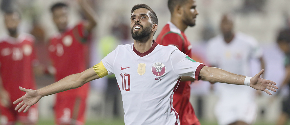 Hassan al-Haydos celebrates after scoring off the penalty spot